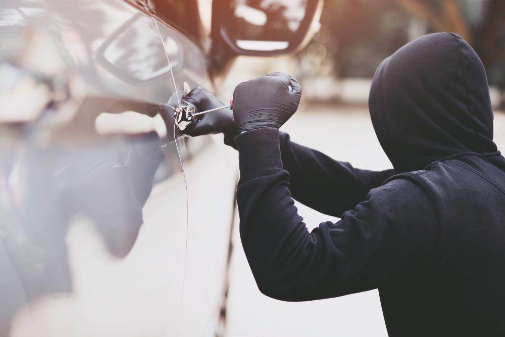 Thief breaking into car