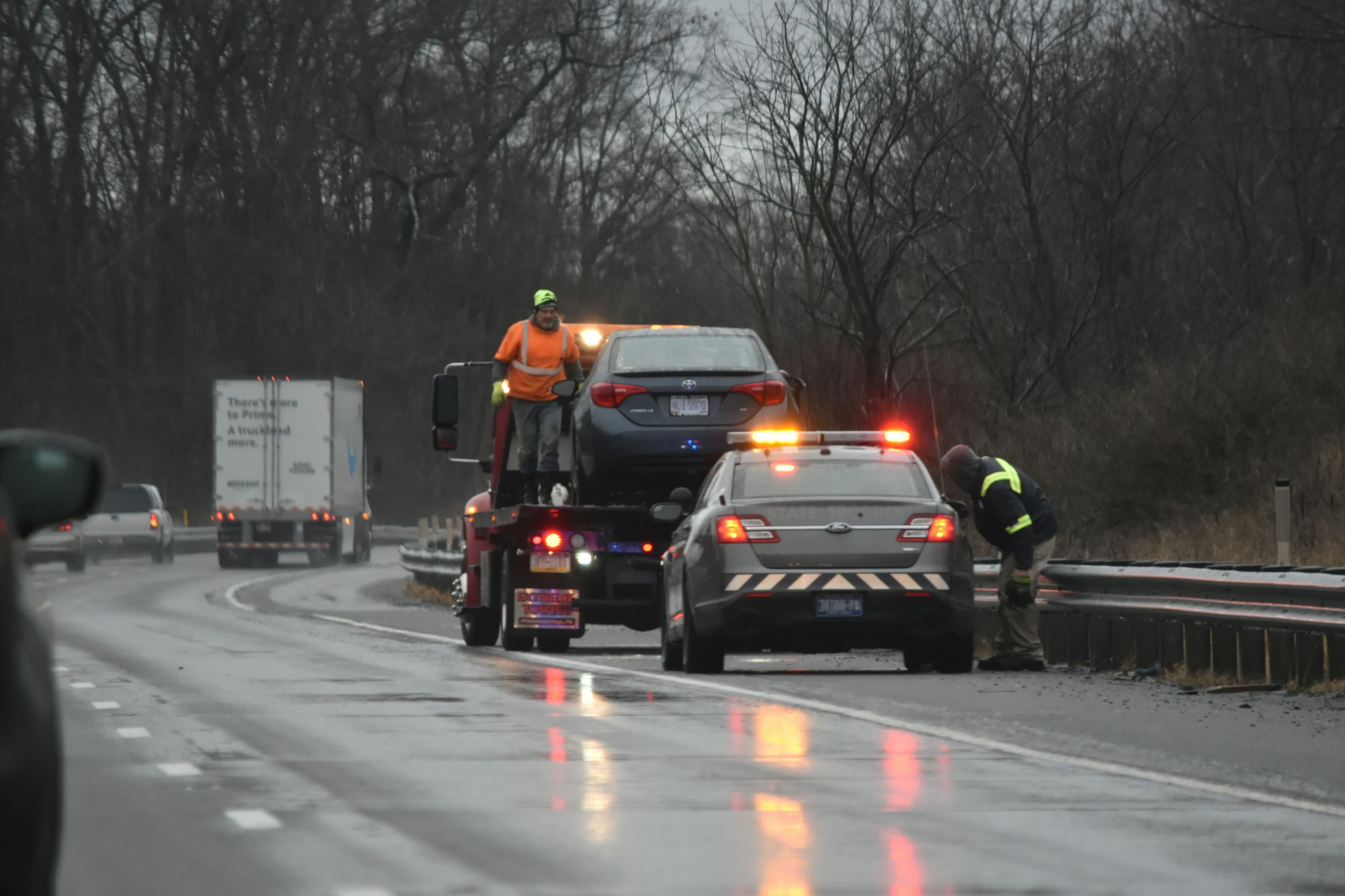 Emergency road and towing services on interstate on wet day in winter disabled vehicle Car accident